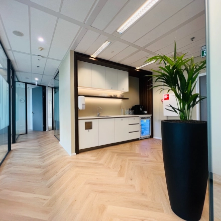 Interior view of modern office space with kitchenette and plant at Vliegend Hertlaan 15, Utrecht South, ideal for office space rental.