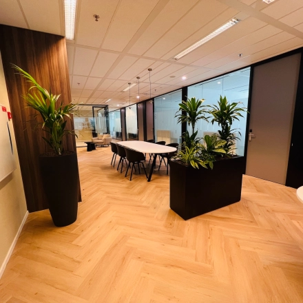 Interior view of an office space in Utrecht South featuring modern furnishings and plants, ideal for rental workspace needs.