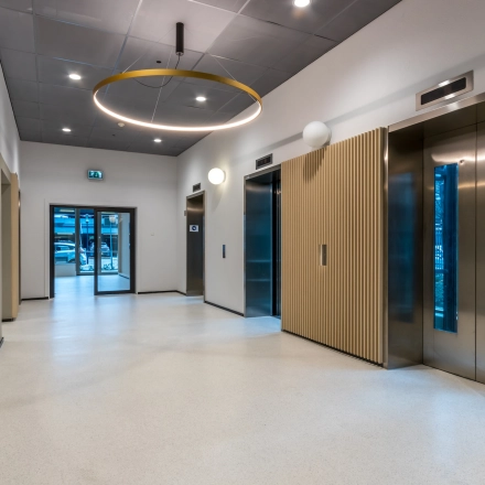 Spacious and modern office entrance with elevators and sleek design, ideal for those looking to rent office space in Utrecht South.