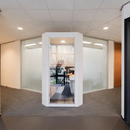 Modern office space for rent at Winthontlaan 200, Utrecht South, featuring a glass-walled workspace with a person working at a desk.