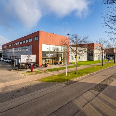 Exterior view of the office building located at Proostwetering 41, Utrecht West, showcasing modern architecture and ample parking, ideal for those seeking office space rental in a vibrant business district.