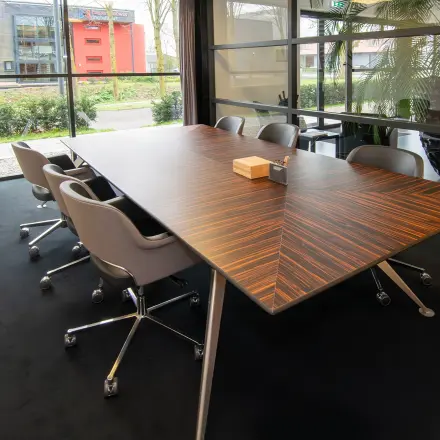 Spacious conference room at Gildestraat 13, Velp with a sleek wooden table and comfortable chairs, ideal for office space rental.
