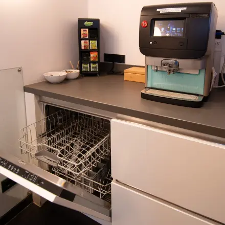 Office space rental kitchen area with a dishwasher and coffee machine at Gildestraat 13, Velp.
