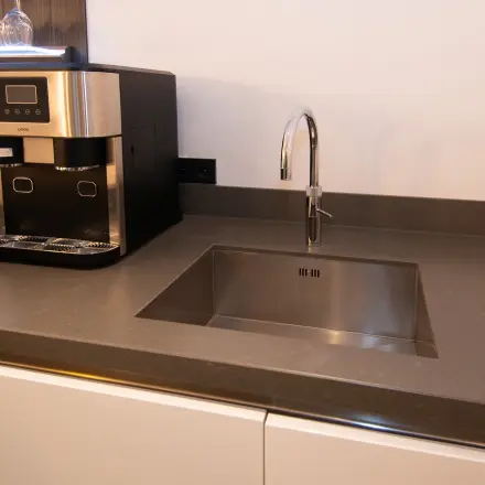 Kitchen area with a sleek counter and modern coffee machine at office space rental in Velp.