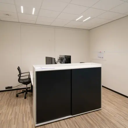 Office space rental at Gildestraat 13, Velp featuring a minimalist interior with a desk and chair, suitable for businesses seeking an office to rent.