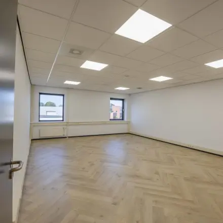 Bright office space with wooden flooring and large windows at Keizersveld 47, Venray, available for rent.