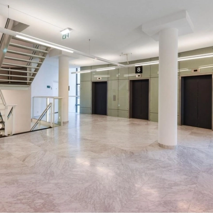 Spacious interior of Regulusweg 11, Voorburg, showcasing elevator lobby, ideal for office space rental with sleek design.