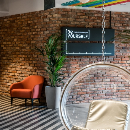 Stylish office space with exposed brick walls and modern decor at Konstruktorska 11 in Warsaw Mokotow, ideal for office space rental.
