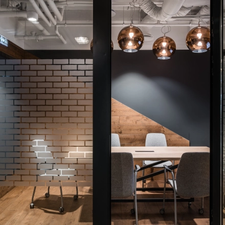 A stylish conference room with a wooden table and modern chairs, located at Konstruktorska 11, Warsaw Mokotow, ideal for office space rental.