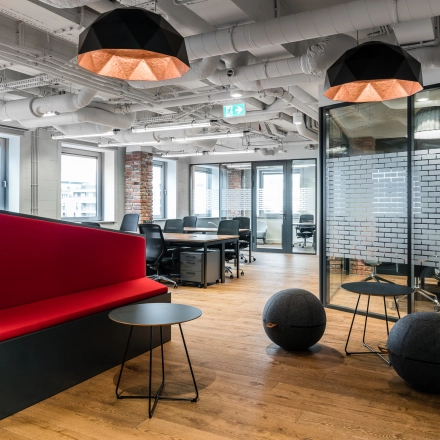 Modern furnished office space for rent at Konstruktorska 11, Warsaw Mokotow, featuring stylish seating and ample workstations.