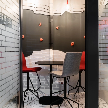 Furnished interior office space at Konstruktorska 11, Warsaw Mokotow, featuring a small meeting area with modern chairs and a table. Ideal for office space rental or office to rent needs.