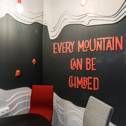 Small meeting area in an office space at Konstruktorska 11, Warsaw Mokotow, featuring a round table and two chairs. Inspirational wall art adds a creative touch to this office space rental.