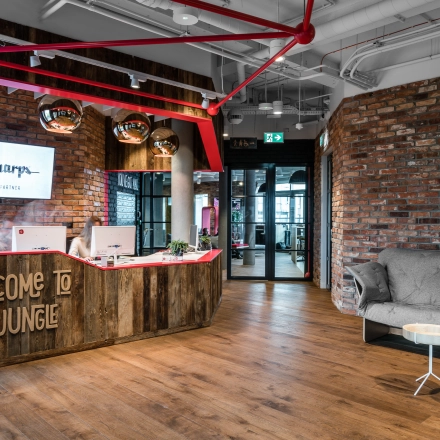 Stylish office space at Konstruktorska 11, Warsaw Mokotow, featuring a welcoming reception area with modern decor and wooden accents. Perfect for office space rental.