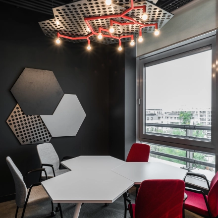 Modern furnished office space at Konstruktorska 11 in Warsaw Mokotow, featuring a unique ceiling design and stylish furniture. Ideal for rent as a collaborative workspace.