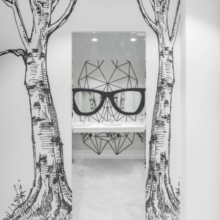 Stylish office restroom at Konstruktorska 11, Warsaw Mokotow with artistic wall designs and modern fixtures. Perfect for office space rental.