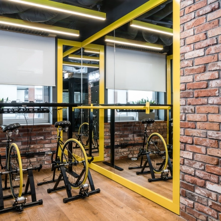 Interior space at Konstruktorska 11, Warsaw Mokotow featuring stationary bicycles, ideal for informal meetings. Consider this office space rental for a dynamic work environment.