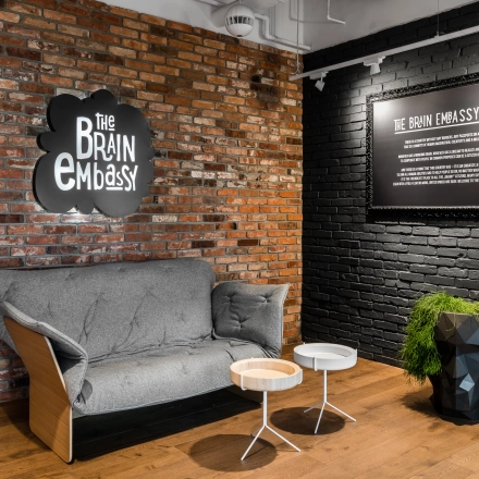 Cozy lounge area at Konstruktorska 11 in Warsaw Mokotow, featuring a comfortable sofa and stylish decor, ideal for office space rental.