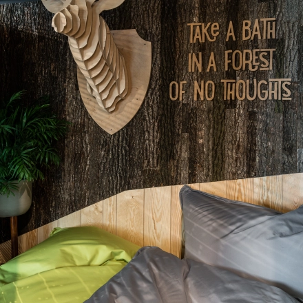 Cozy lounge area with beanbags, creative wall decor, and unique wooden animal sculpture at Konstruktorska 11, in Warsaw Mokotow office space rental.