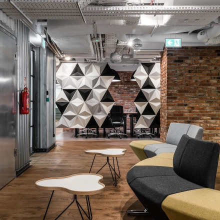 Modern office interior at Konstruktorska 11, Warsaw Mokotow with stylish seating area and unique geometric decor, ideal for office space rental.