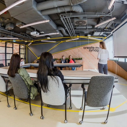 Business meeting in a stylish office space with modern furnishings at Al. Jerozolimskie 181B, Warsaw Ochota. Perfect for office space rental or finding an office to rent.