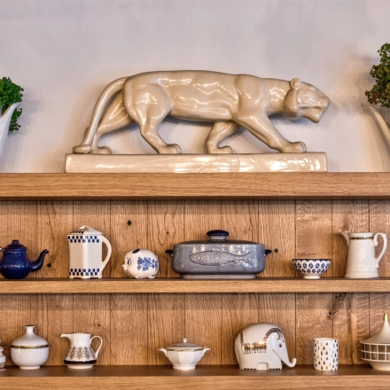Decorative shelves in an office at Koszykowa 65, Warsaw, featuring ceramics and plants.