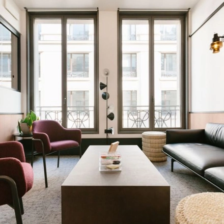 Modern office space with a sleek sofa, coffee table, and two chairs, ideal for office space rental in Warsaw Śródmieście.