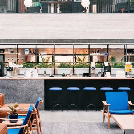 Modern office lounge with a central bar at Grzybowska 60, Warsaw Wola, ideal for office space rental.