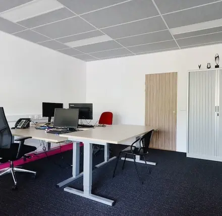 A furnished office space available to rent at Molenweer 2, Wateringen, featuring desks, chairs, and computer monitors in a bright, tidy environment.