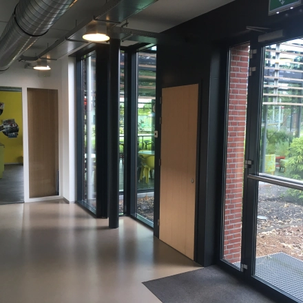 Bright entrance area with large windows and modern design elements located at M.A. Reinaldaweg 2d, Woerden, ideal for those looking to rent office space.
