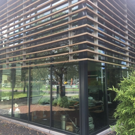 Exterior of an office building at M.A. Reinaldaweg 2d in Woerden, showcasing modern glass architecture suitable for office space rental.