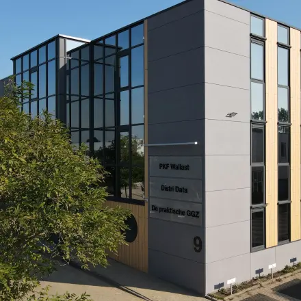 Exterior view of the office building at Pompmolenlaan 9, showcasing a modern facade with large windows suitable for office space rental.