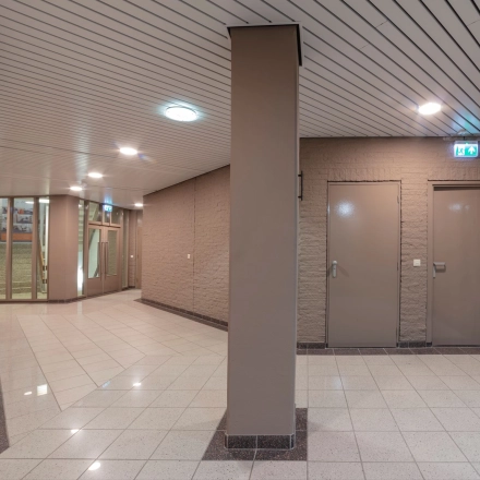 Interior view of an office space for rent at Zaagmolenlaan 4, Woerden featuring a hallway with tiled floors and beige walls.