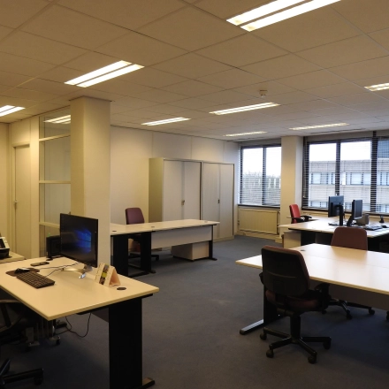 Spacious office space to rent at Zaagmolenlaan 4, Woerden, featuring multiple desks and chairs, ideal for professional workspaces.