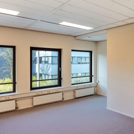 Bright office space at Mercurion 24, Zevenaar, featuring large windows and ample natural light, perfect for anyone looking to rent office space. This office to rent offers a serene working environment.