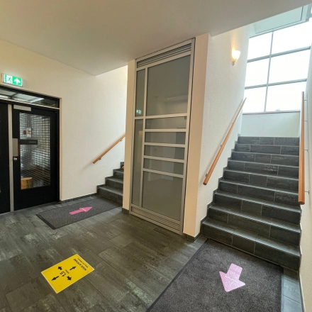 Entrance area at Baron de Coubertinlaan 35, Zoetermeer, featuring clean stairs and signage ideal for office space rental.