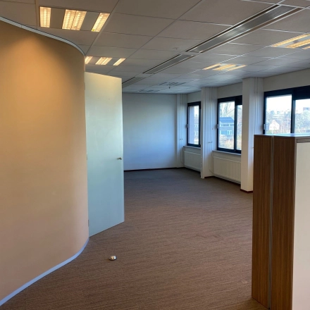 Office space at Bredewater 26, Zoetermeer, featuring a modern layout with carpeted floors and large windows, ideal for office space rental.