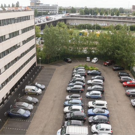 Exterior of the office building at Bredewater 26 in Zoetermeer, featuring a spacious parking area suitable for convenient office space rental access.