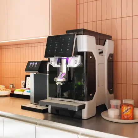 A modern pantry area featuring a sleek coffee machine and various condiments on a countertop, ideal for office space rental at Beethovenstrasse 48, Zürich Enge.