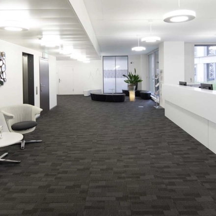 Spacious modern office at Europaallee 41, Zürich Mitte, featuring a sleek design with neutral tones and contemporary furniture. Ideal for office space rental.