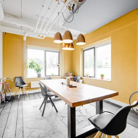 Bright office space at Hanzeplein 11-27, Zwolle with a wooden table, chairs, and decorative bicycles, ideal for office space rental.