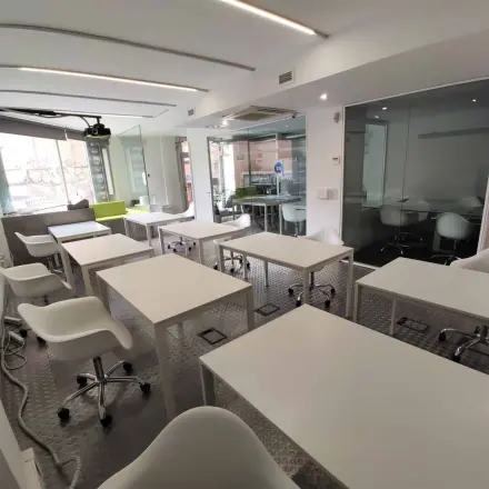 Espacio de oficinas en Carrer Albigesos 25-27 en Barcelona Gràcia, configurado con mesas modernas y sillas, ideal para quienes buscan alquiler de oficinas.