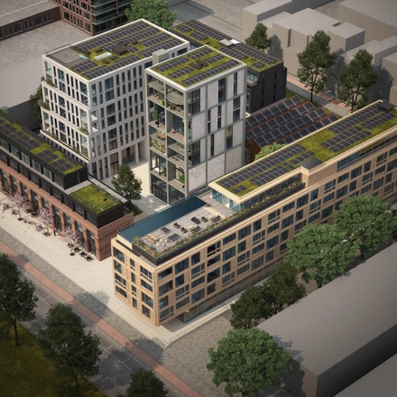 Luchtfoto van kantoorpand op Papaverhof 58 in Amsterdam Noord met grote ramen en groene daken. Dit kantoor biedt moderne ruimtes voor huur.