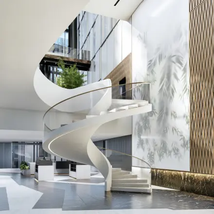 Helder verlichte entree van het kantoorpand met een stijlvolle, moderne draaitrap op Claude Debussylaan 80-134, Amsterdam Zuidas, perfect voor bedrijven die kantoorruimte willen huren.