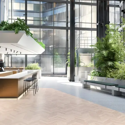 Moderne en lichte kantoorruimte op Claude Debussylaan 80-134 in Amsterdam Zuidas, met groene planten en een stijlvol interieur, ideaal voor huur en zakelijke activiteiten.