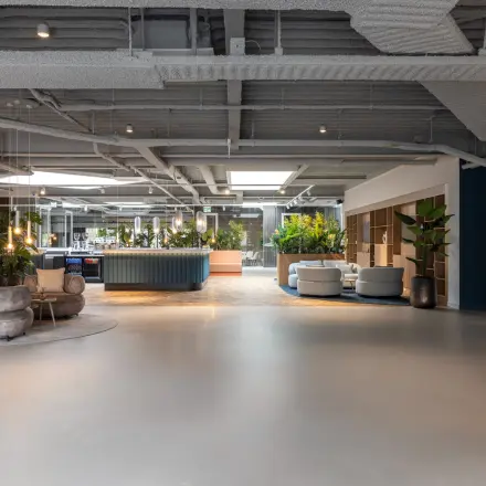 Ruime en moderne kantoorpandinterieur met comfortabele zitgedeeltes en veel groen, geschikt voor kantoorruimte huren aan de Essebaan 63, Capelle aan den IJssel.