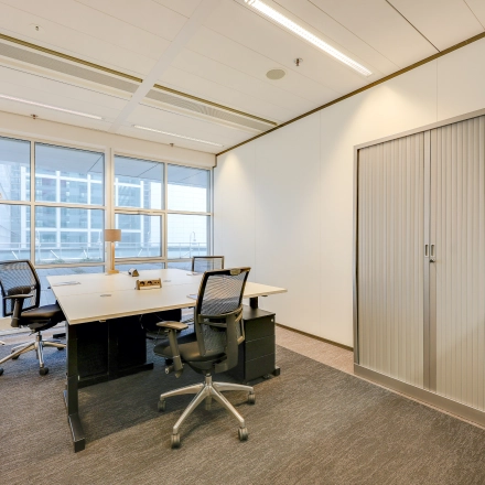 Modern ingerichte kantoorruimte te huur op Kalvermarkt 53, Den Haag Centrum. Voorzien van bureaus, stoelen, kasten en grote ramen voor veel natuurlijk licht, ideaal voor zakelijke activiteiten.
