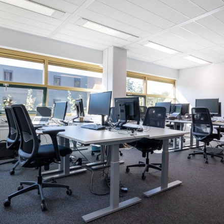 Lichte kantoorruimte in Gouda aan Groningenweg 8 8 met diverse bureaus en stoelen, ideaal voor kantoor huren. Grote ramen zorgen voor veel natuurlijk licht.