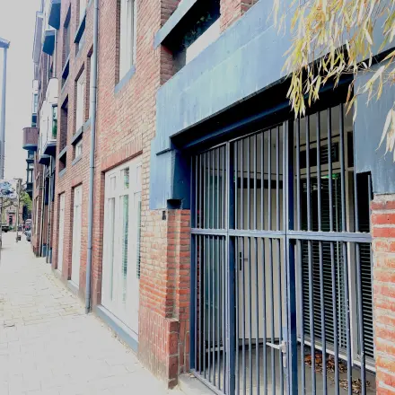 Exterieur van kantoorpand op Wilhelminasingel 44-46 in Maastricht met rode bakstenen en metalen hekwerk bij de entree. Ideaal voor wie een kantoorruimte wil huren.