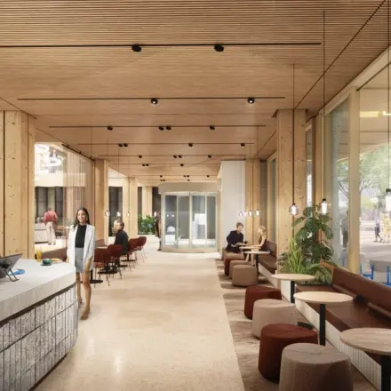 Moderne kantoorruimte huren aan de Coolsingel 75 in Rotterdam Centrum, met een open en lichte werkruimte waar mensen aan tafels zitten en zakelijke activiteiten uitvoeren.