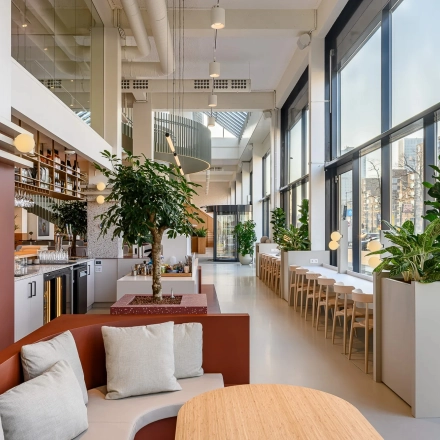 Modern ingerichte kantoorruimte op Vasteland 42-110 in Rotterdam Centrum, met veel natuurlijk licht en ruime werkplekken. Planten en comfortabele zitplaatsen zijn aanwezig voor een aangename werkomgeving.